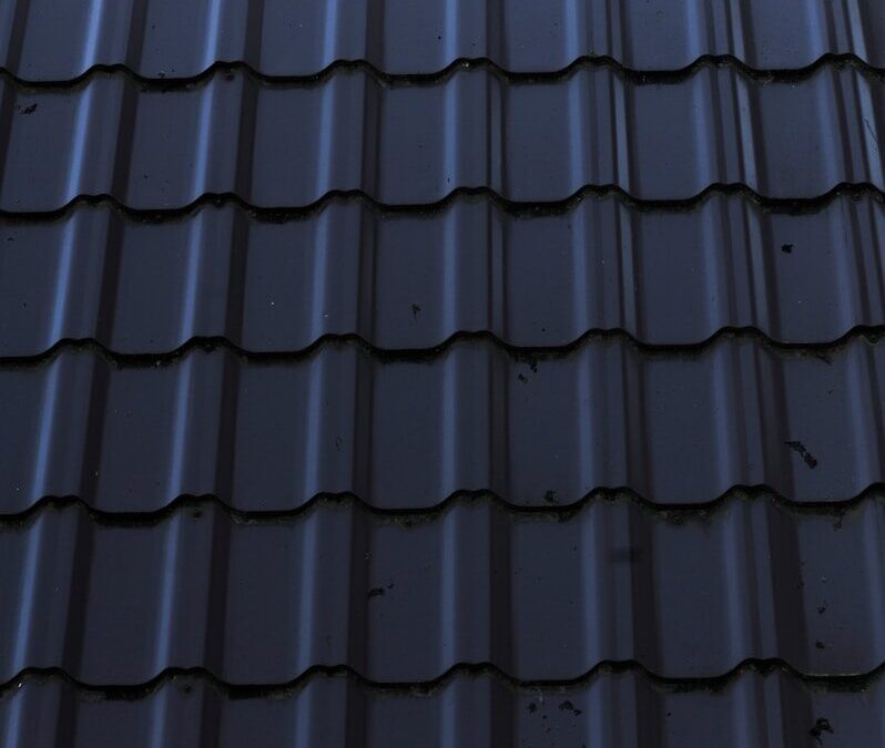 a close up of a metal roof with a sky background